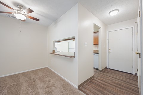a bedroom with a ceiling fan and a door to a bathroom