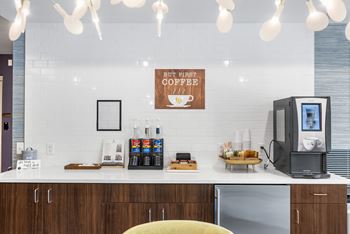 A coffee shop interior with a sign that says "but first coffee".