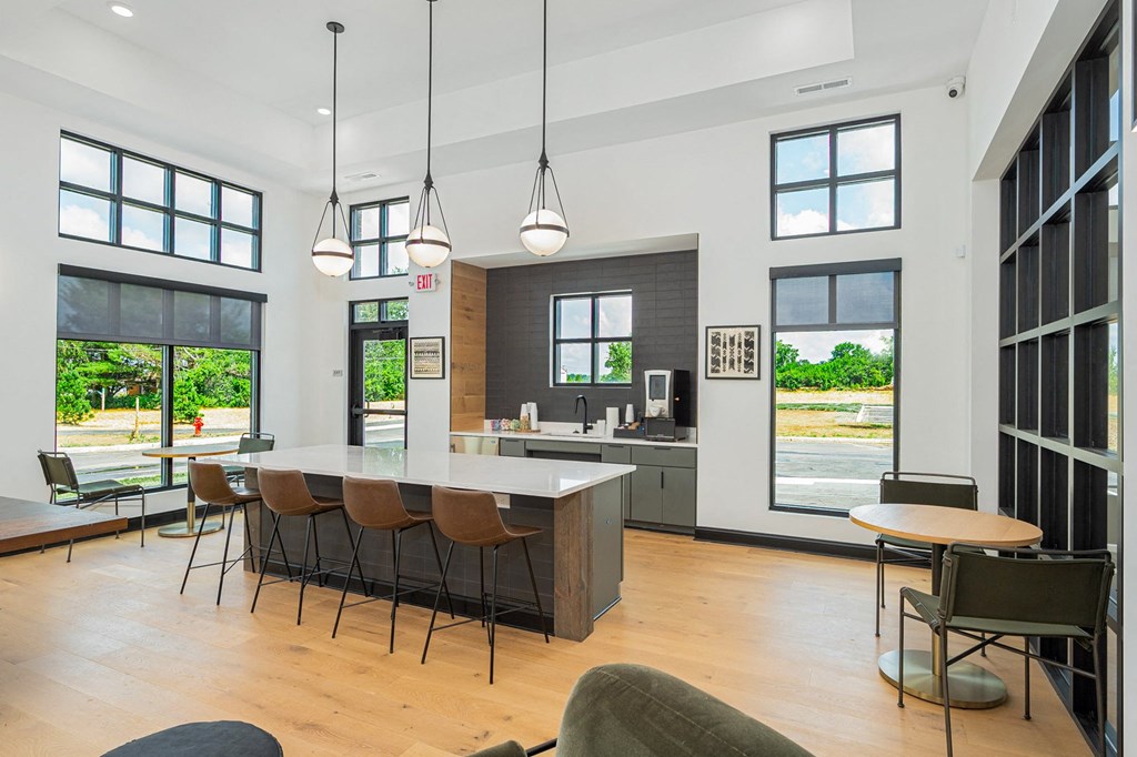 a living room with a kitchen and a table with chairs
