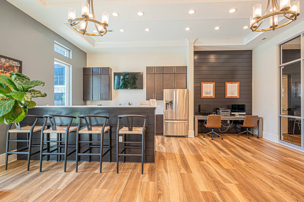 a dining room with a bar and a kitchen with a table and chairs