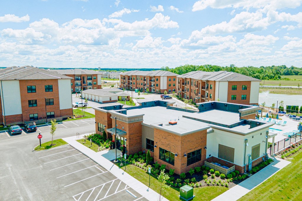 an aerial view of an apartment complex with a parking lot