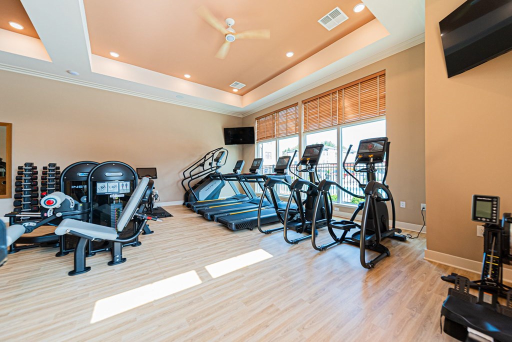 A spacious home gym with a variety of exercise equipment.