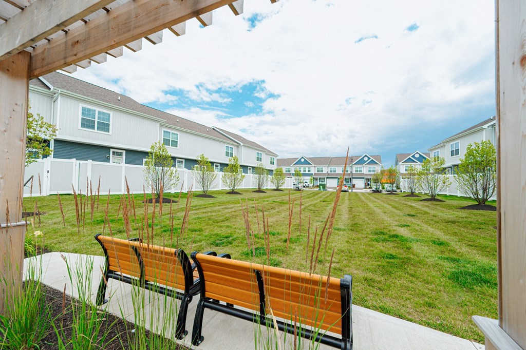 a group of benches in front of some houses