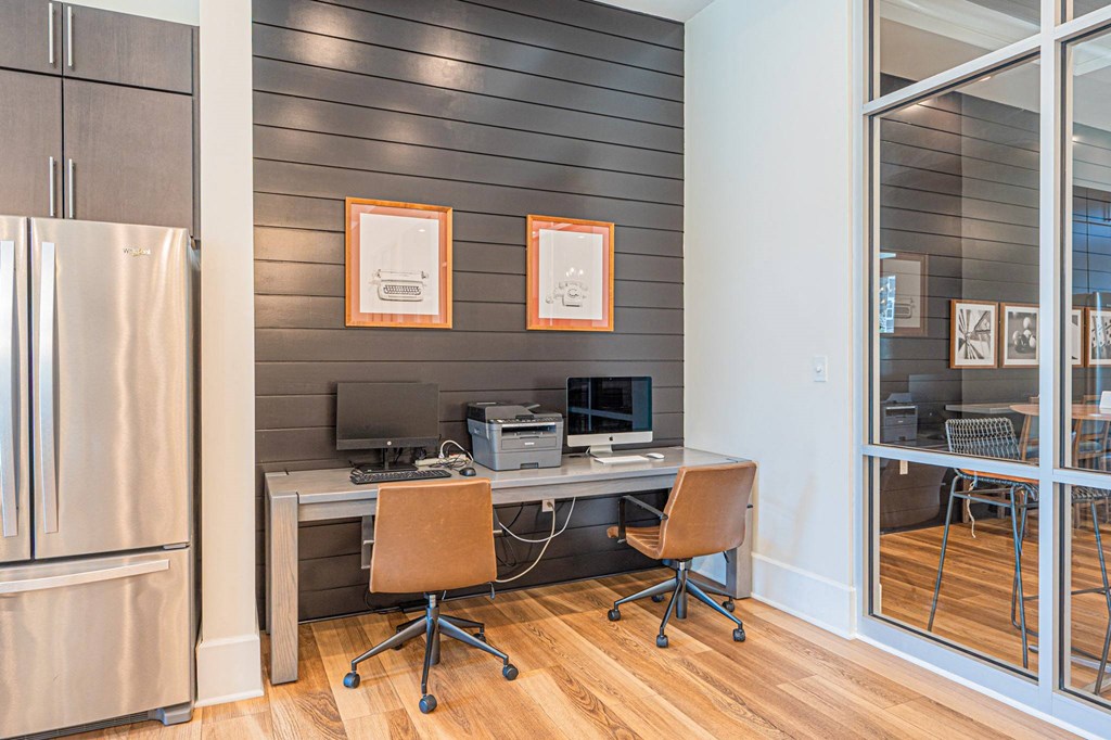a home office with a desk and a refrigerator