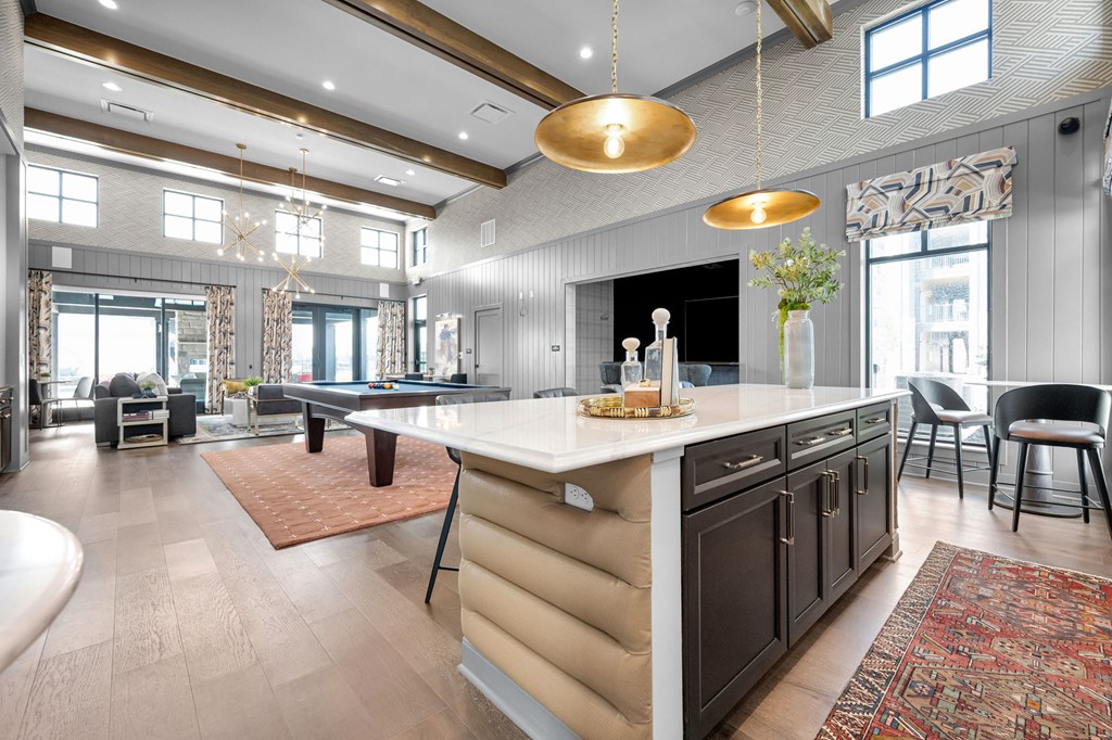 A modern kitchen with a large island and a dining area.