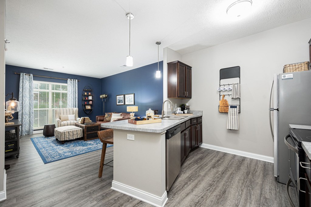 our apartments offer a kitchen and living room with a blue accent wall