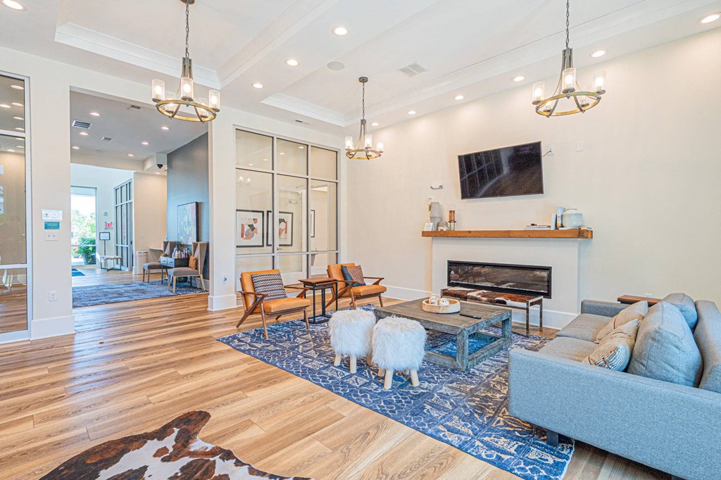 a living room with two sheep in front of a fireplace