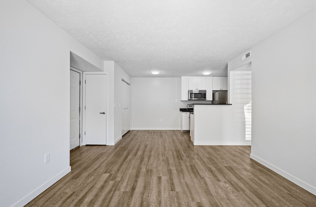 A room with a wooden floor and white walls.