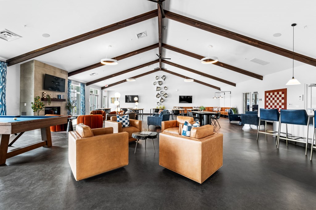 A room with a pool table and a couch.