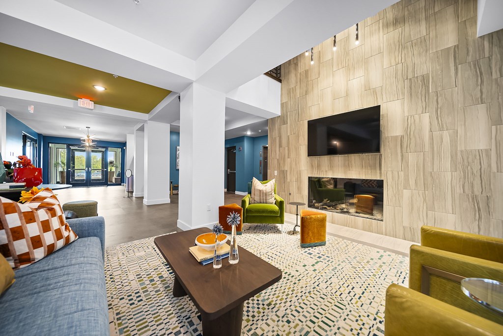 A living room with a fireplace and a television on the wall.