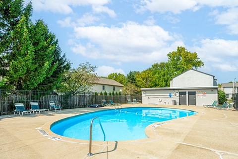 our apartments have a resort style pool with chairs and a fence