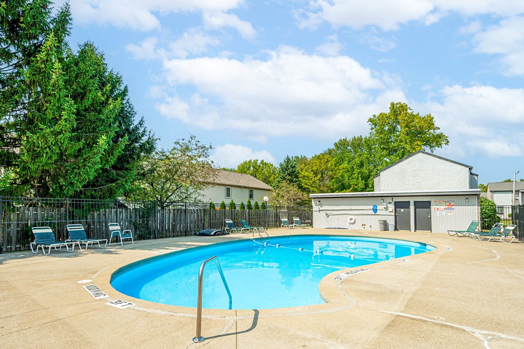 our apartments have a resort style pool with chairs and a fence