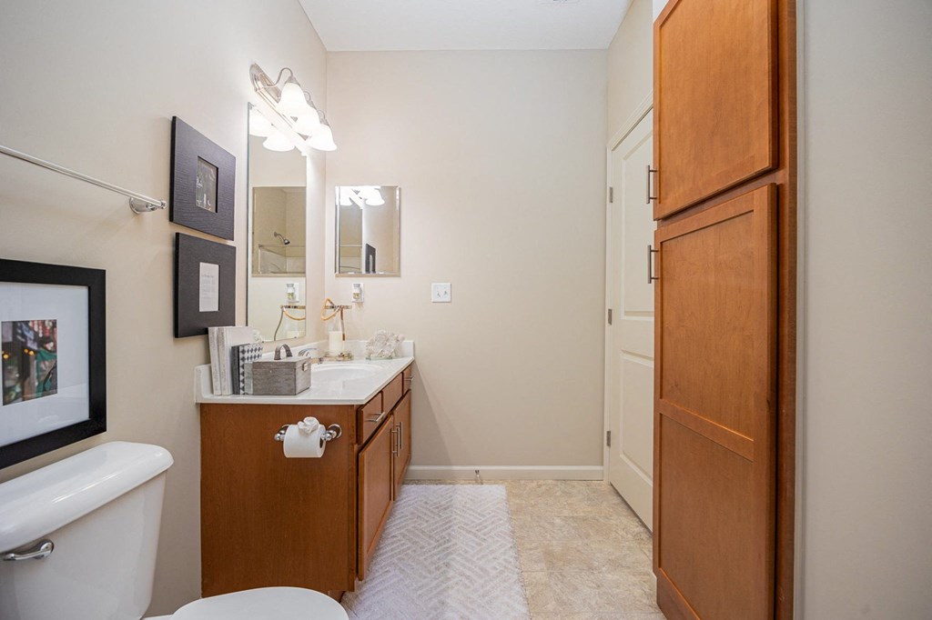 A bathroom with a white tub, sink, and toilet.