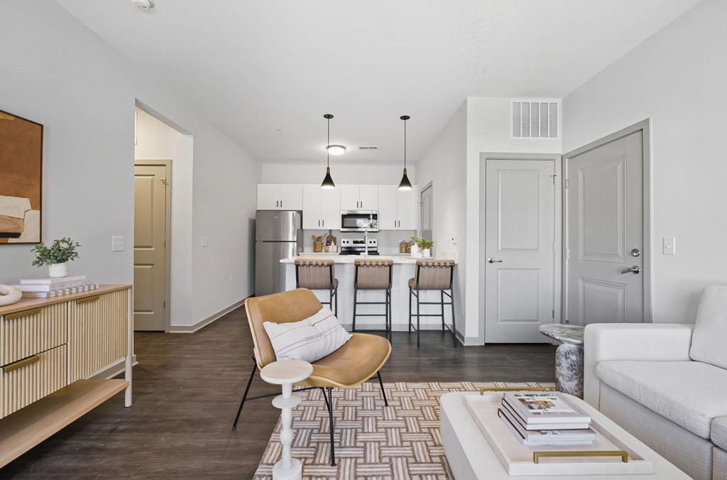 A modern kitchen with a dining table and chairs.