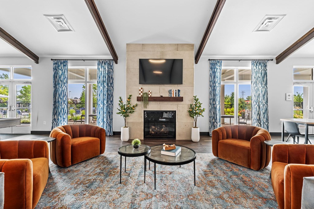 A living room with a fireplace and a television.