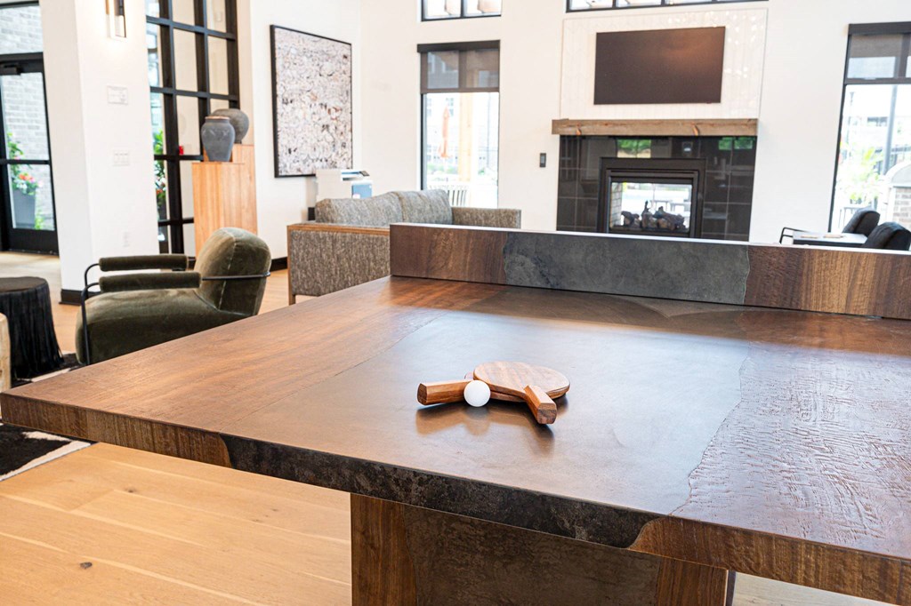 a large communal table in a living room with a fireplace