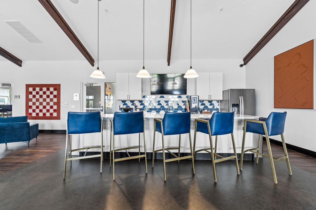 A dining room with a checkered red and white wallpaper on the wall.