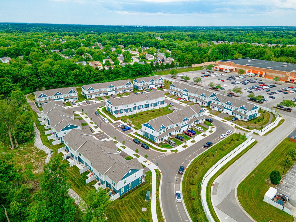 an aerial view of a group of houses and a parking lot