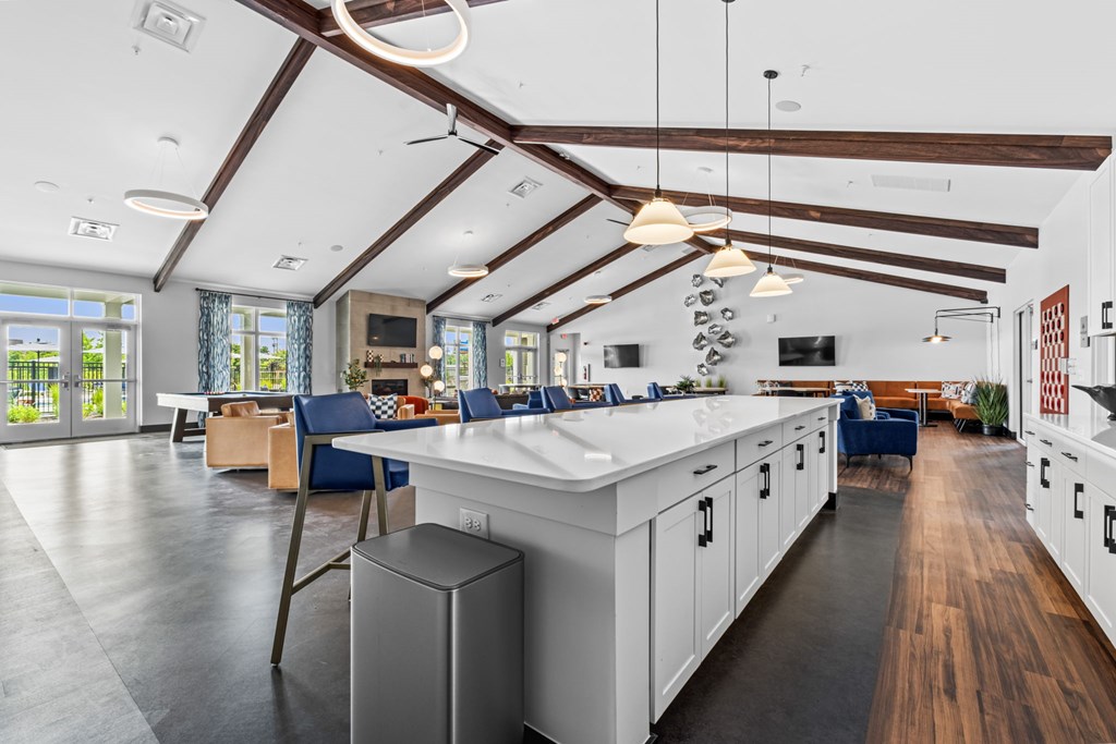 A modern kitchen with white cabinets and a large island.