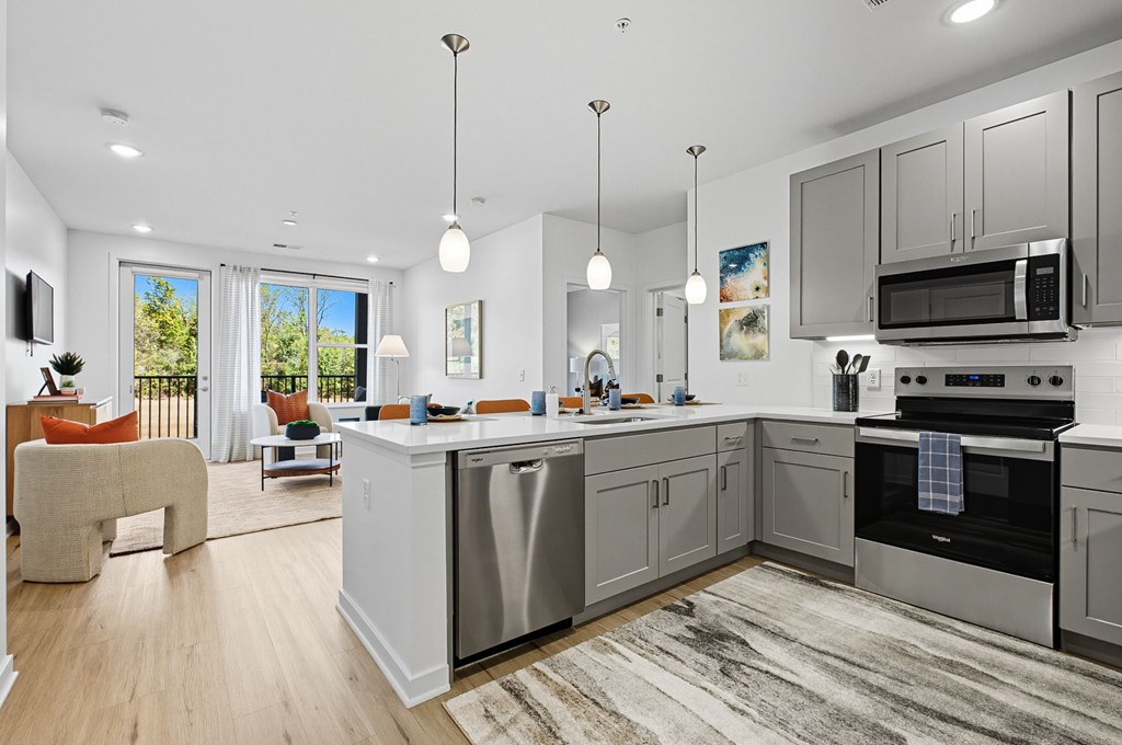 A modern kitchen with a large island and stainless steel appliances.