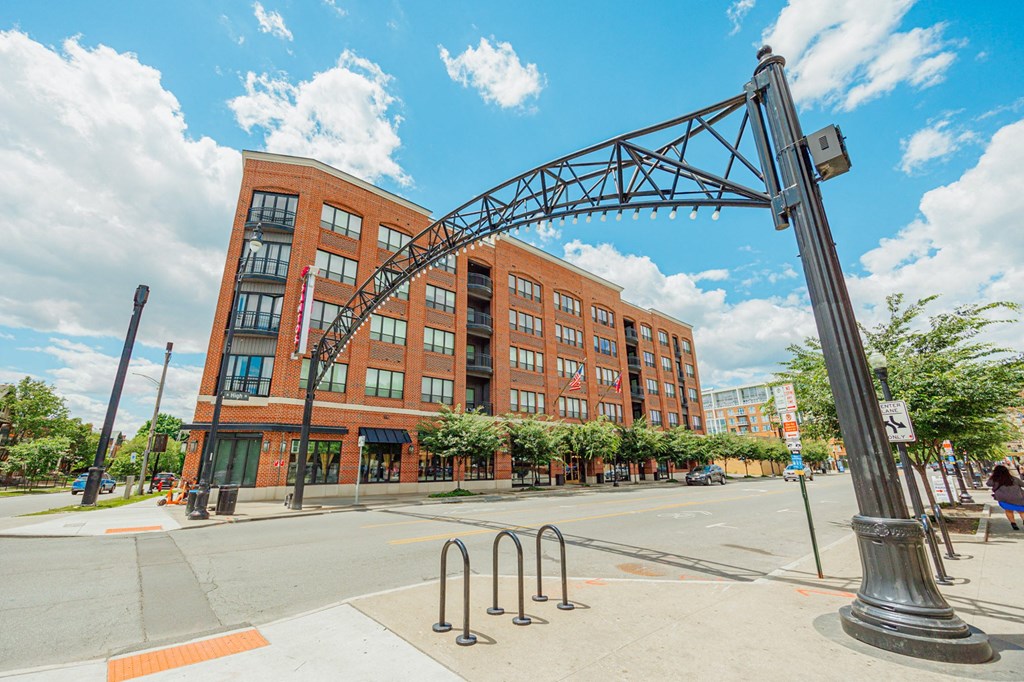 a large brick building with an arch over a street