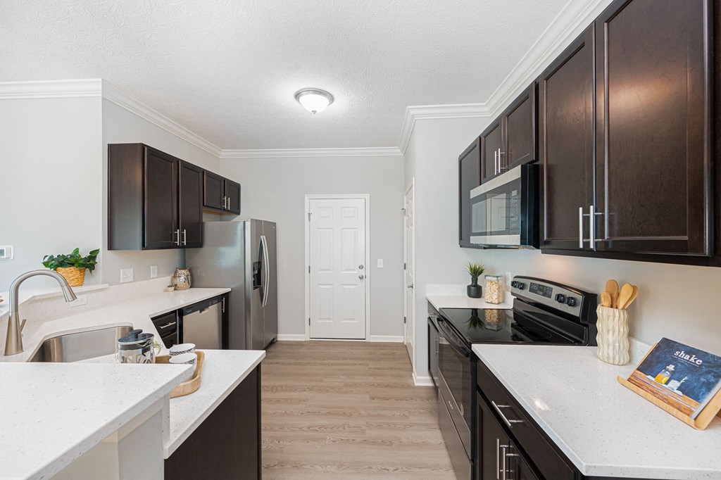 a kitchen with black appliances and white counter tops