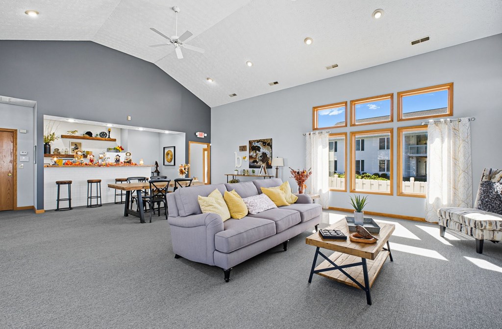 A living room with a grey couch and a wooden coffee table.