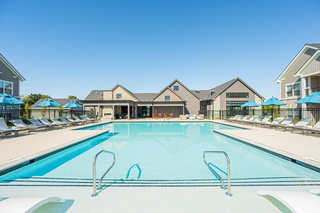 A large swimming pool with a building in the background.