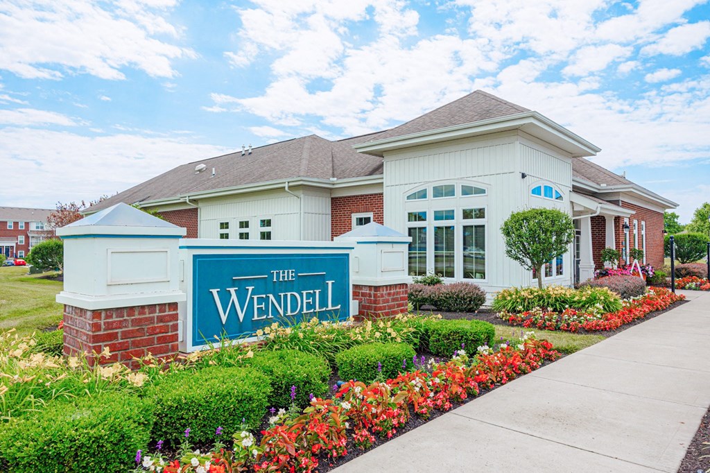 the residences at the wendel building entrance with flowers and plants
