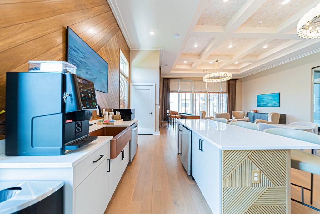A modern kitchen with a white countertop and wooden cabinets.