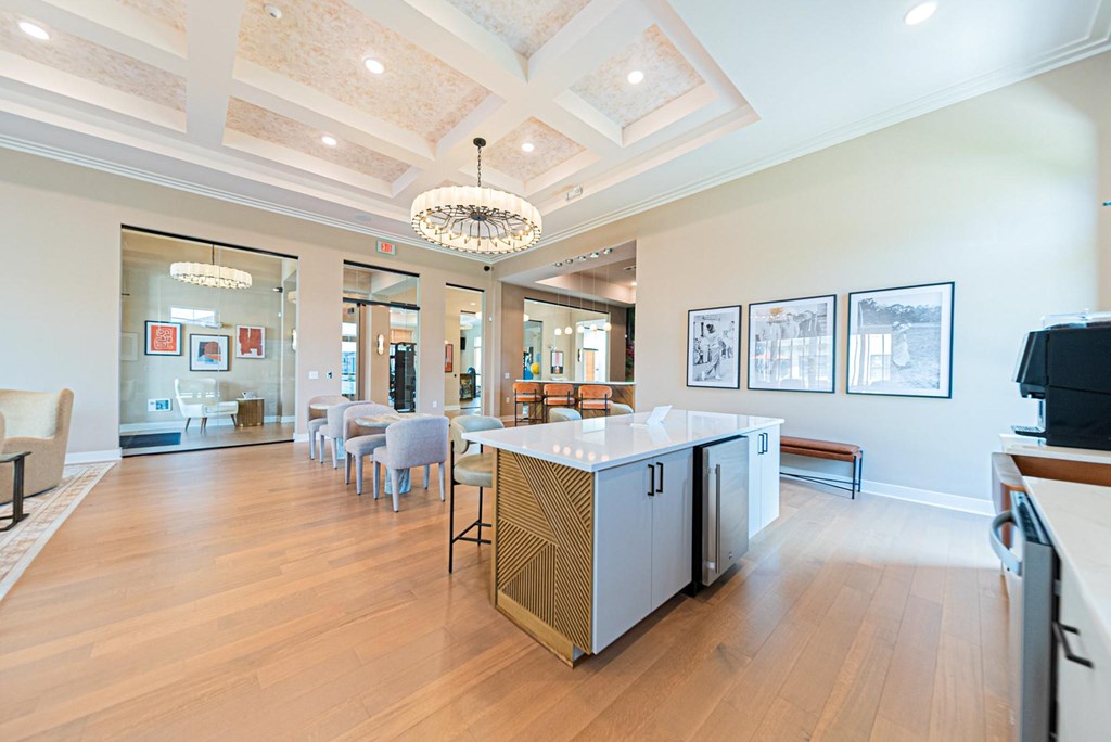 A kitchen with a wooden floor and a white ceiling.