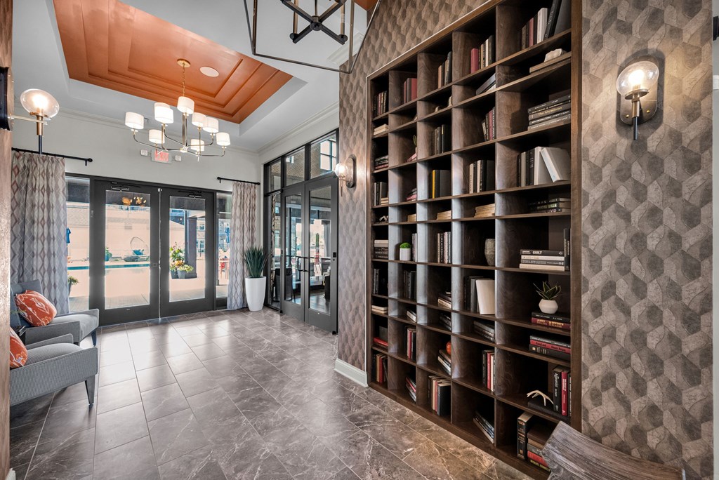 A large bookshelf filled with books in a room with a wooden ceiling.