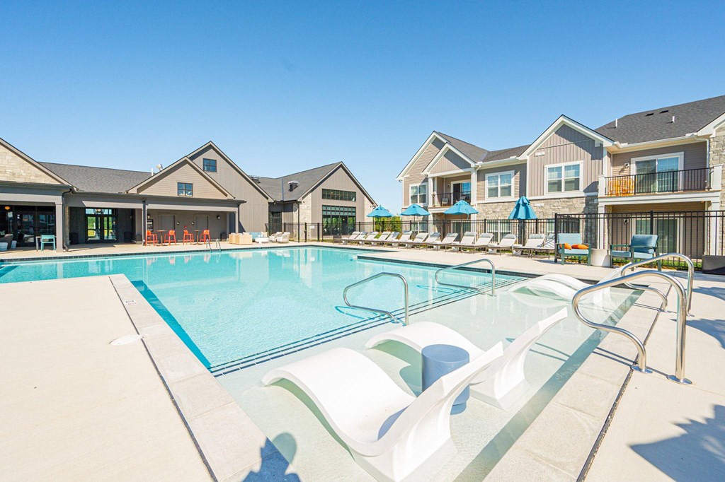 A swimming pool with a slide in front of a building.