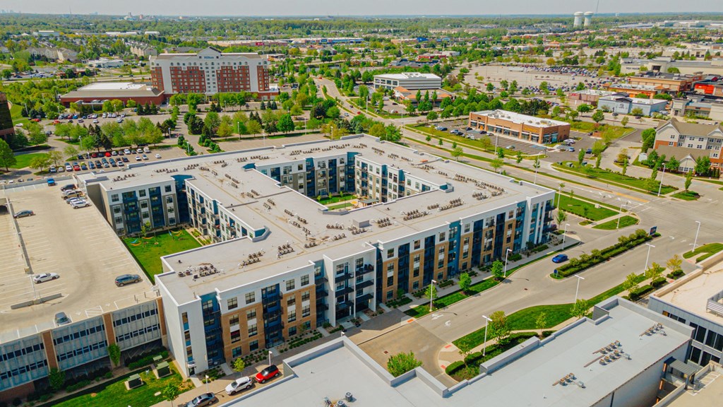 an aerial view of a city with several buildings and a parking lot