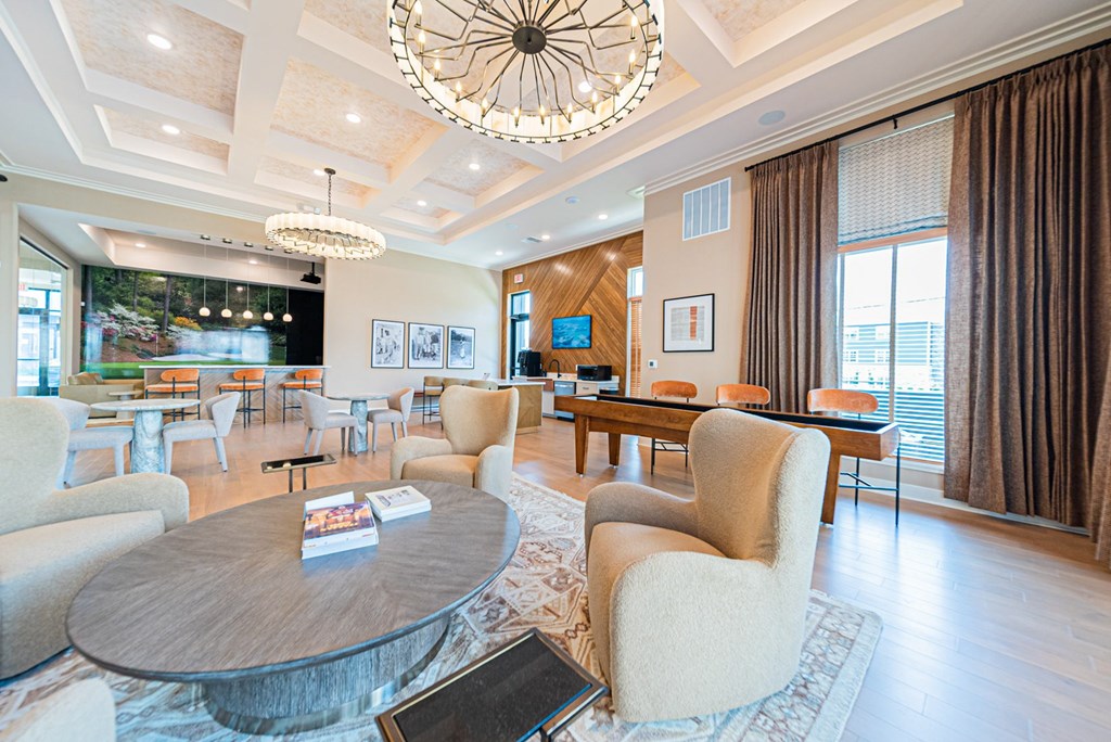 A modern living room with a large circular coffee table at the center.