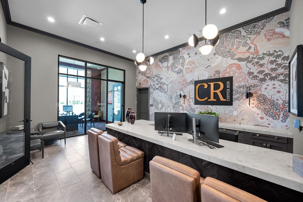 A reception area with a counter and chairs.