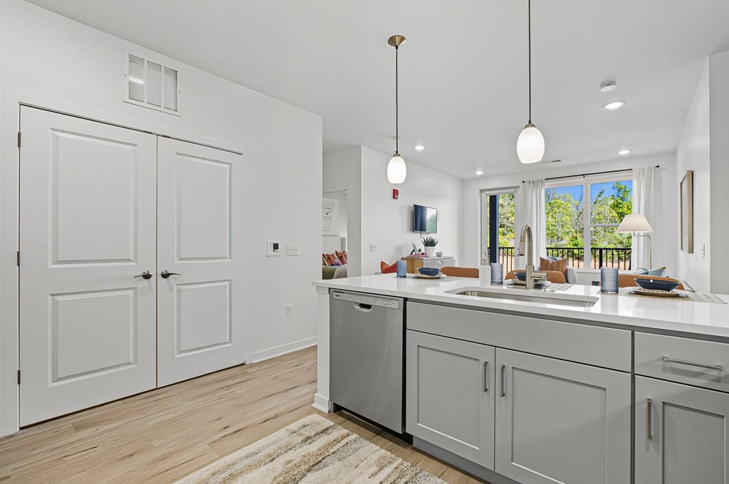 A modern kitchen with white cabinets and a large island.