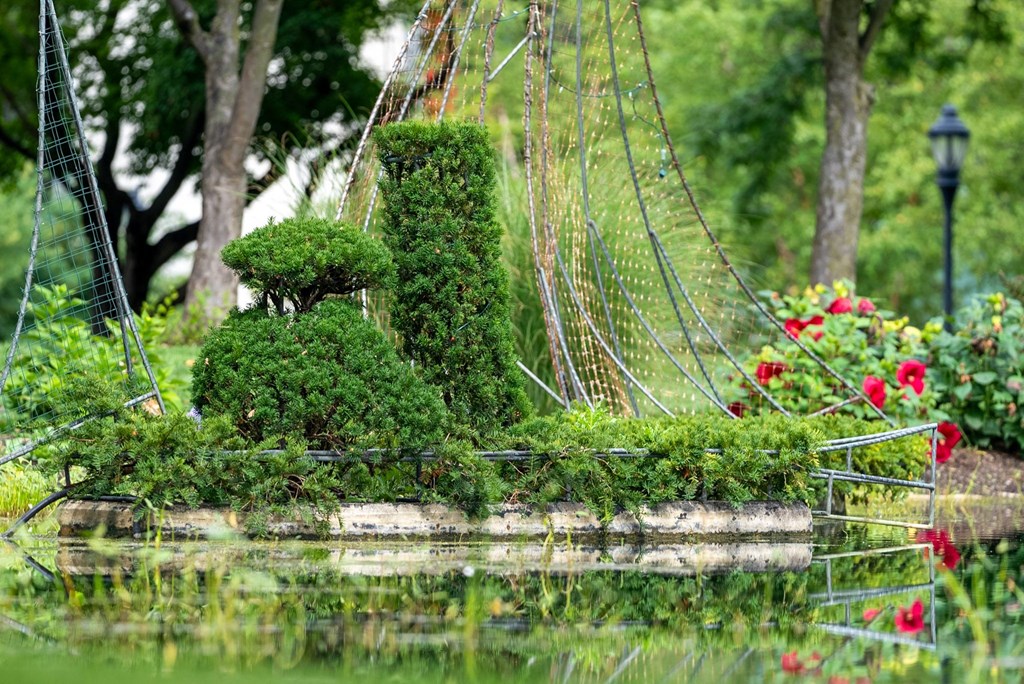 a garden with a bridge over a body of water