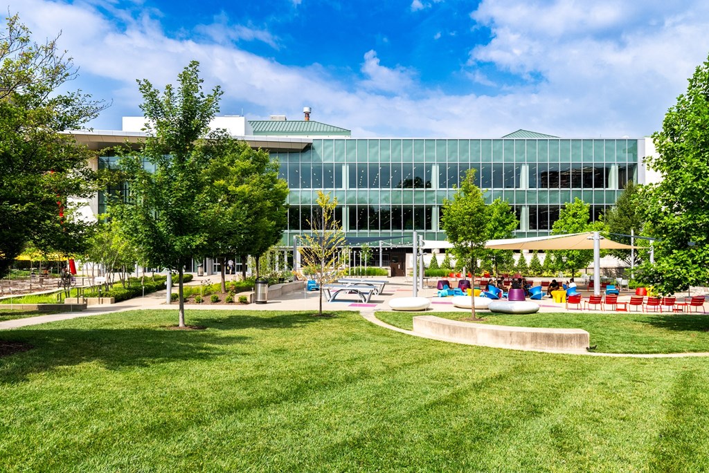 a large building with a park in front of it