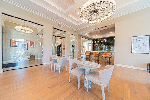 A dining room with a table and chairs.