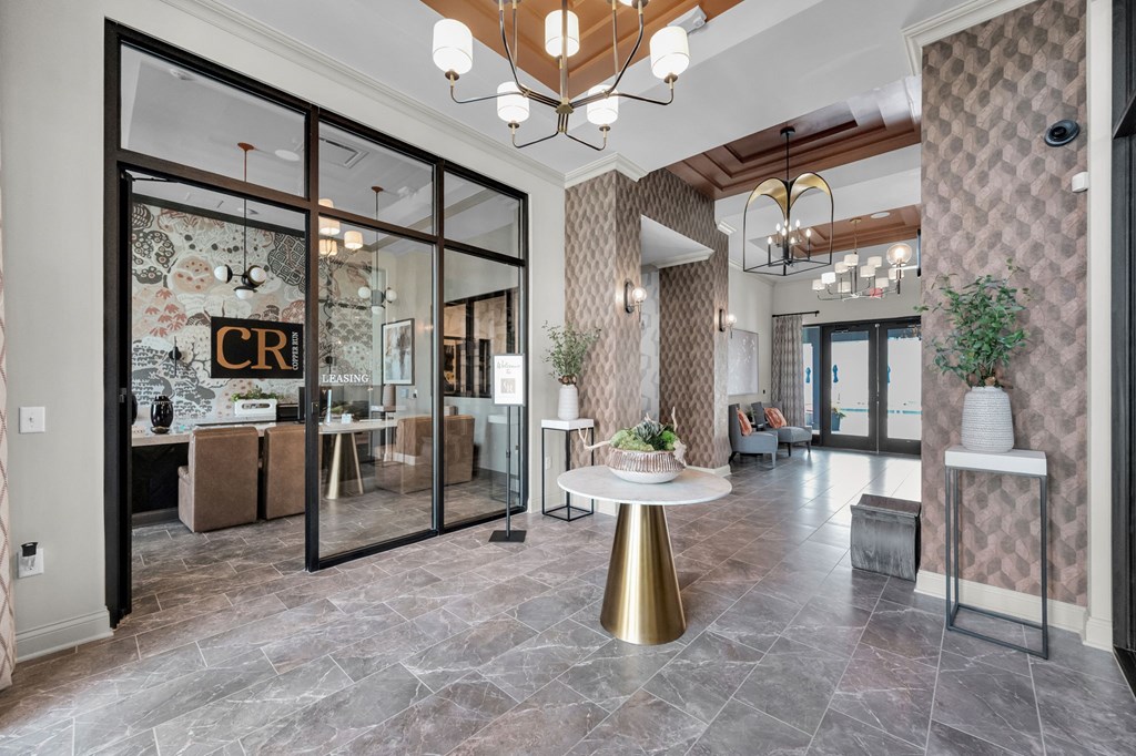 A modern interior with a glass door entrance and a round table in the center.