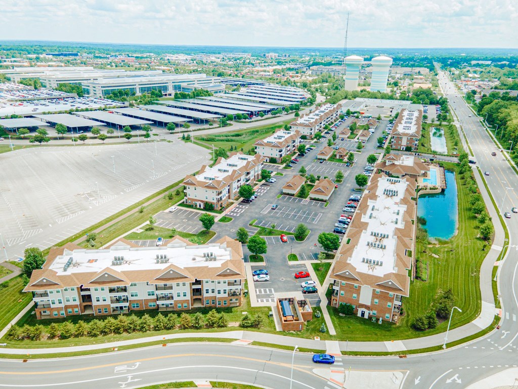 an aerial view of a city with buildings and a parking lot