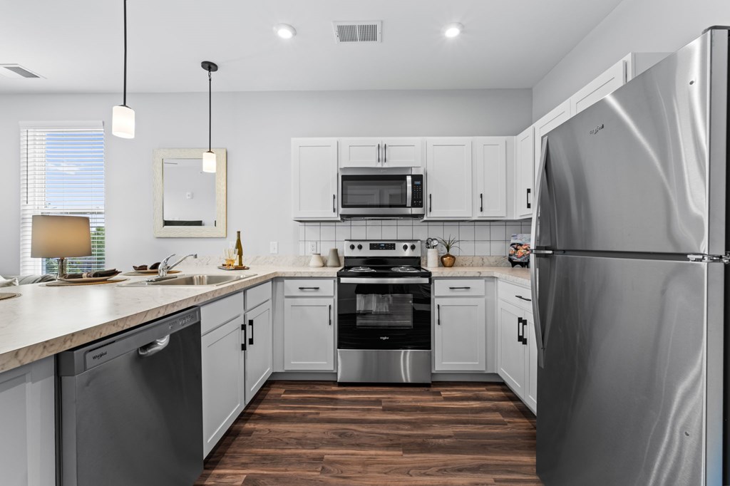 A modern kitchen with a refrigerator on the right.