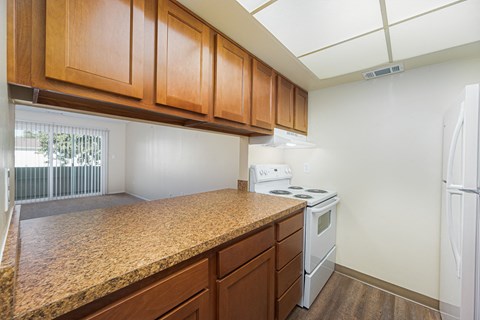 a kitchen with a granite counter top and white appliances