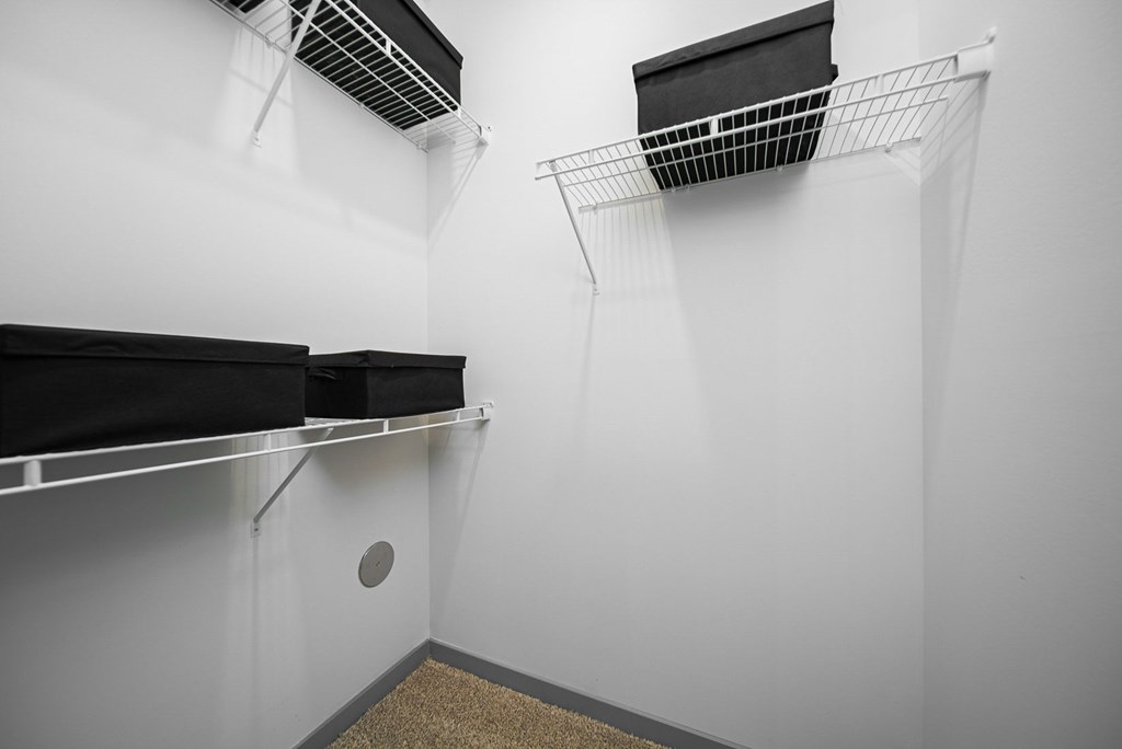 A storage room with two shelves and a ventilation system.