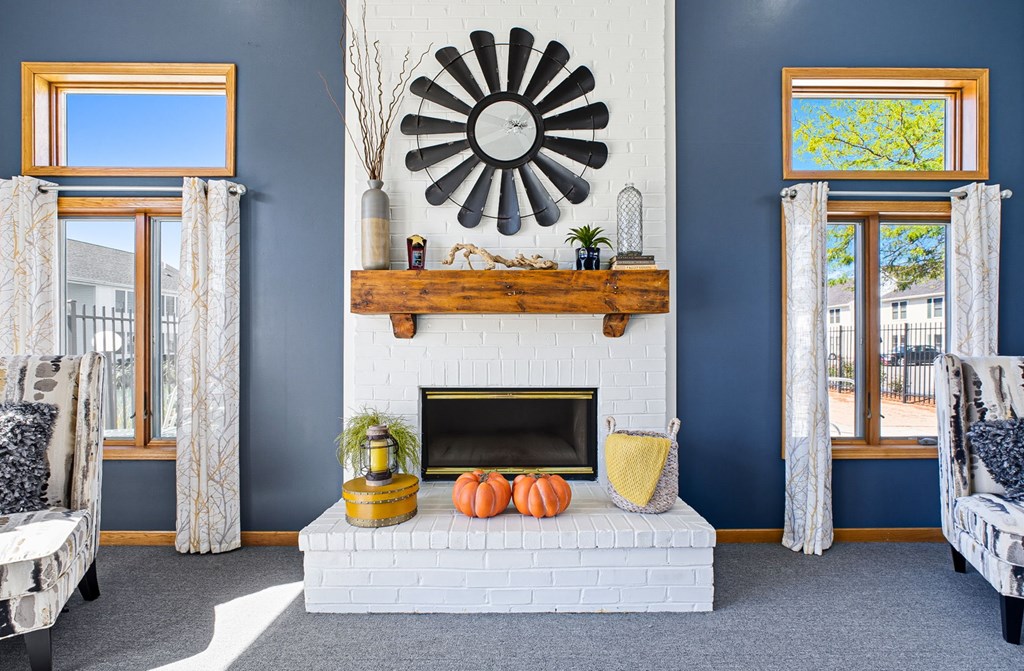 A living room with a fireplace and a mirror on the wall.