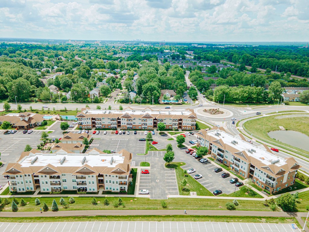 an aerial view of an apartment complex and parking lot