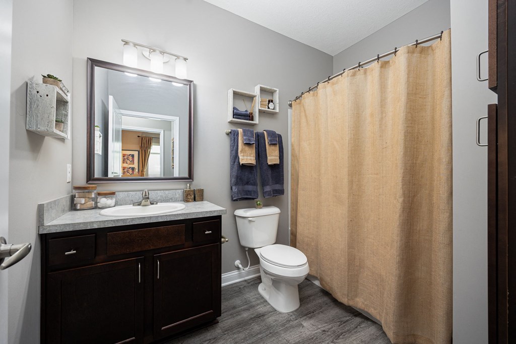 a bathroom with a shower and a sink and a toilet
