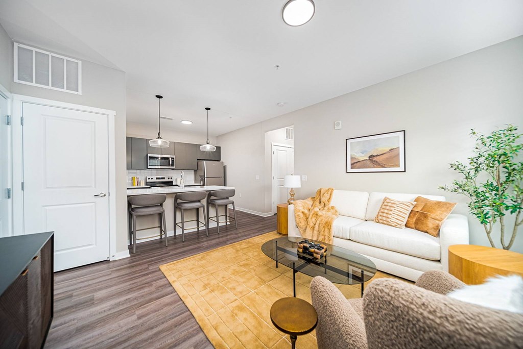 A living room with a white couch and a coffee table.