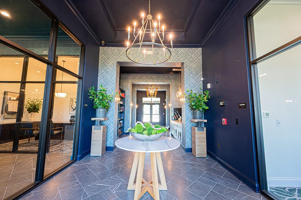 A foyer with a table and chairs in the middle.